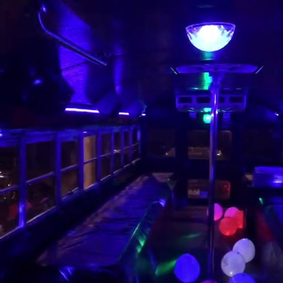 Blue interior lights and balloons inside Nene's Party Bus